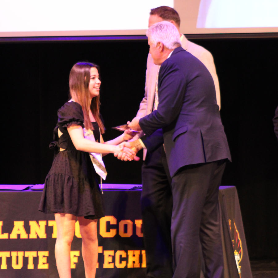 Anya Bariexca, a junior student in the Performing Arts program, accepting her certificate from Dr. Philip Guenther and Mr. Joseph Potkay.