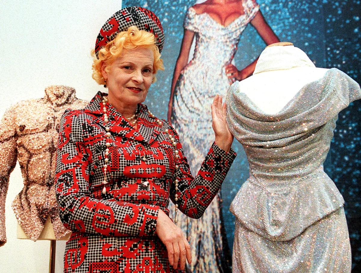 British fashion designer Vivienne Westwood poses with one of her creations on May 5 1999, on display at Christies in Vienna with more than 20 dresses inspired by 18th century France.